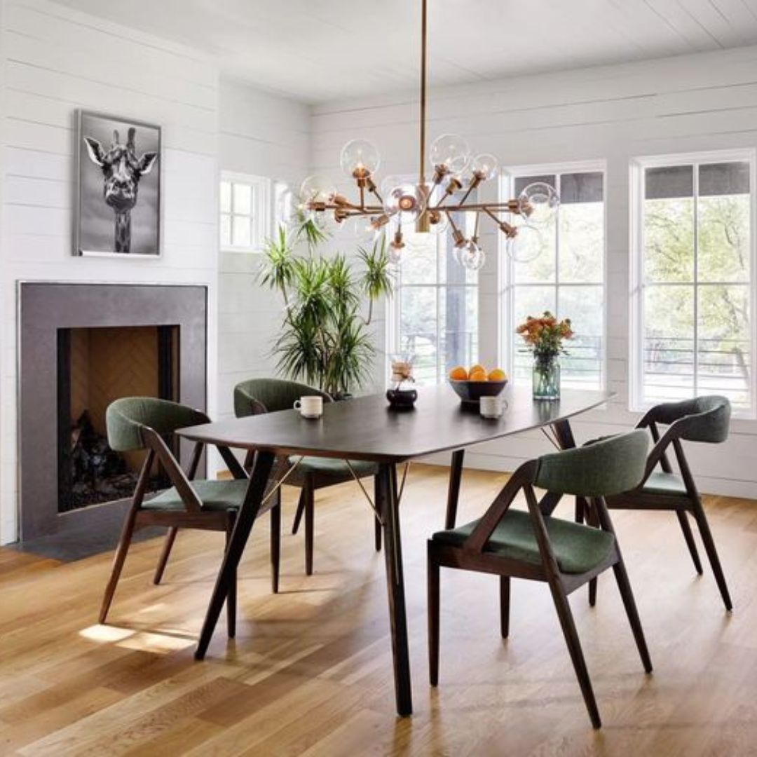 dining room with mid century modern decor including furniture with tapered legs and chandelier lighting fixture
