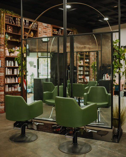 green salon chairs in rustic salon
